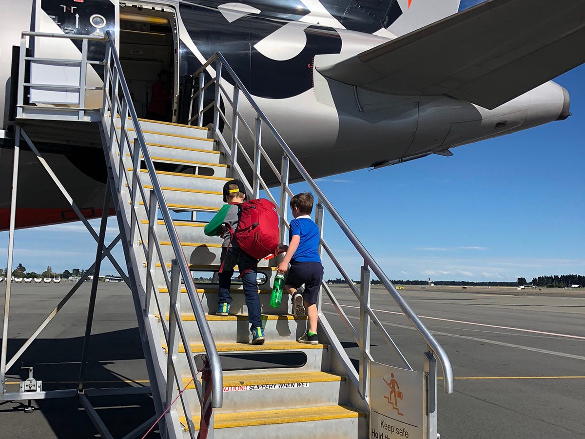 two kids walking on a plane