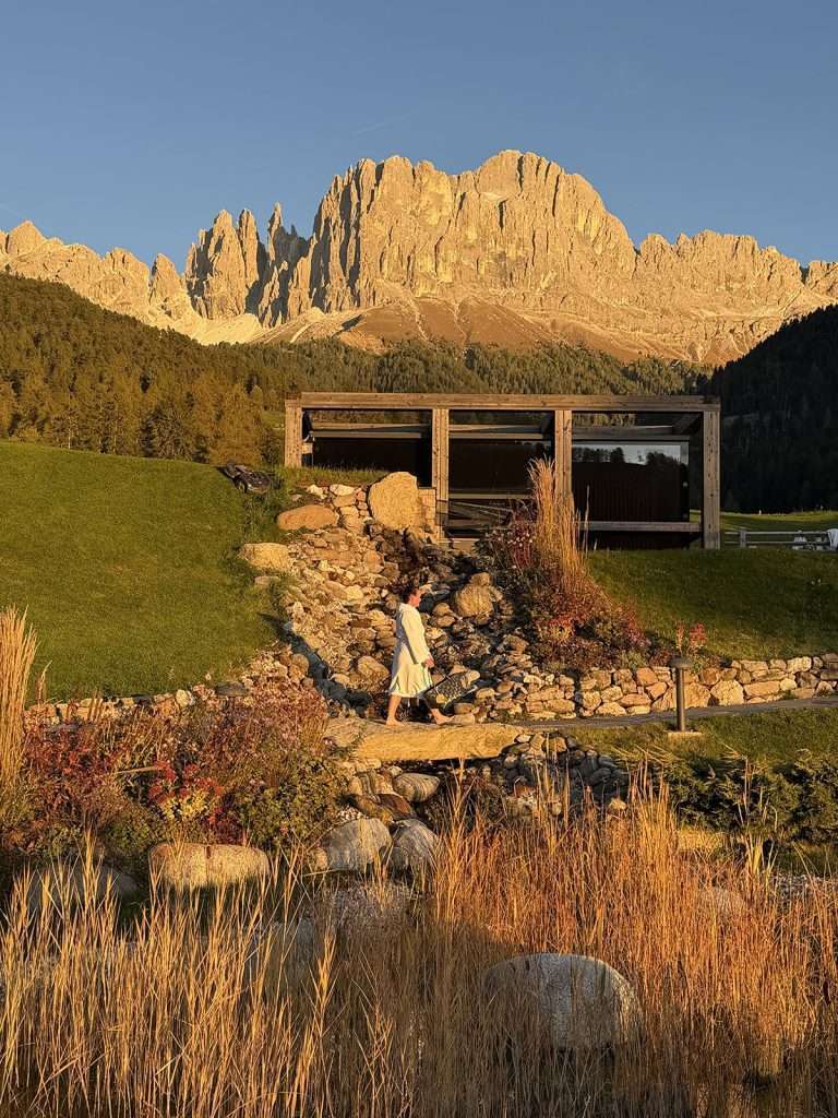 visiting the sauna with dramtic dolomites peaks in the background