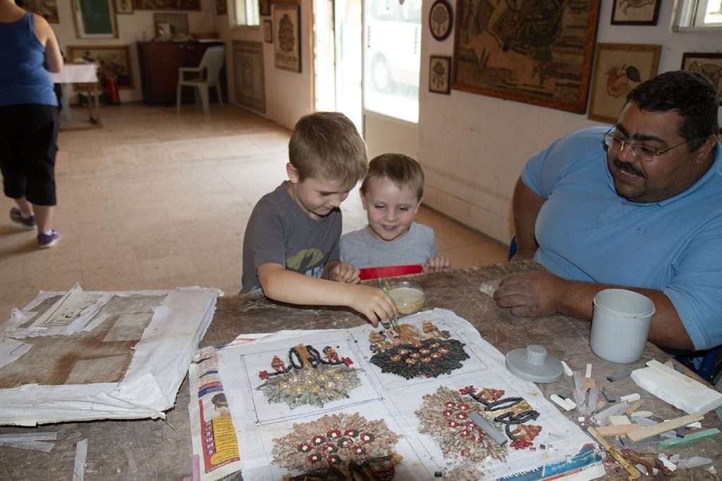 two boys making mosaics in Madaba