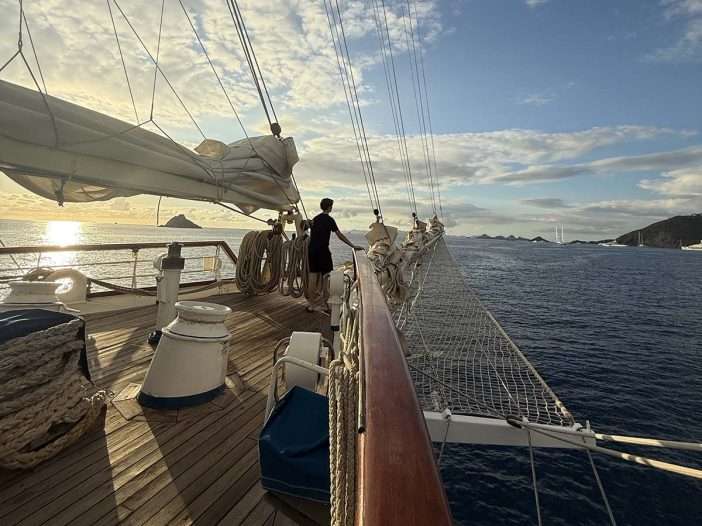 Star Clipper Sailing Vessel with teen on bow of ship