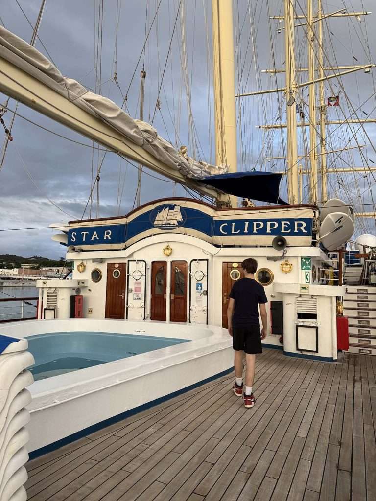 Star Clipper sun deck with views of two state rooms and pool with teen