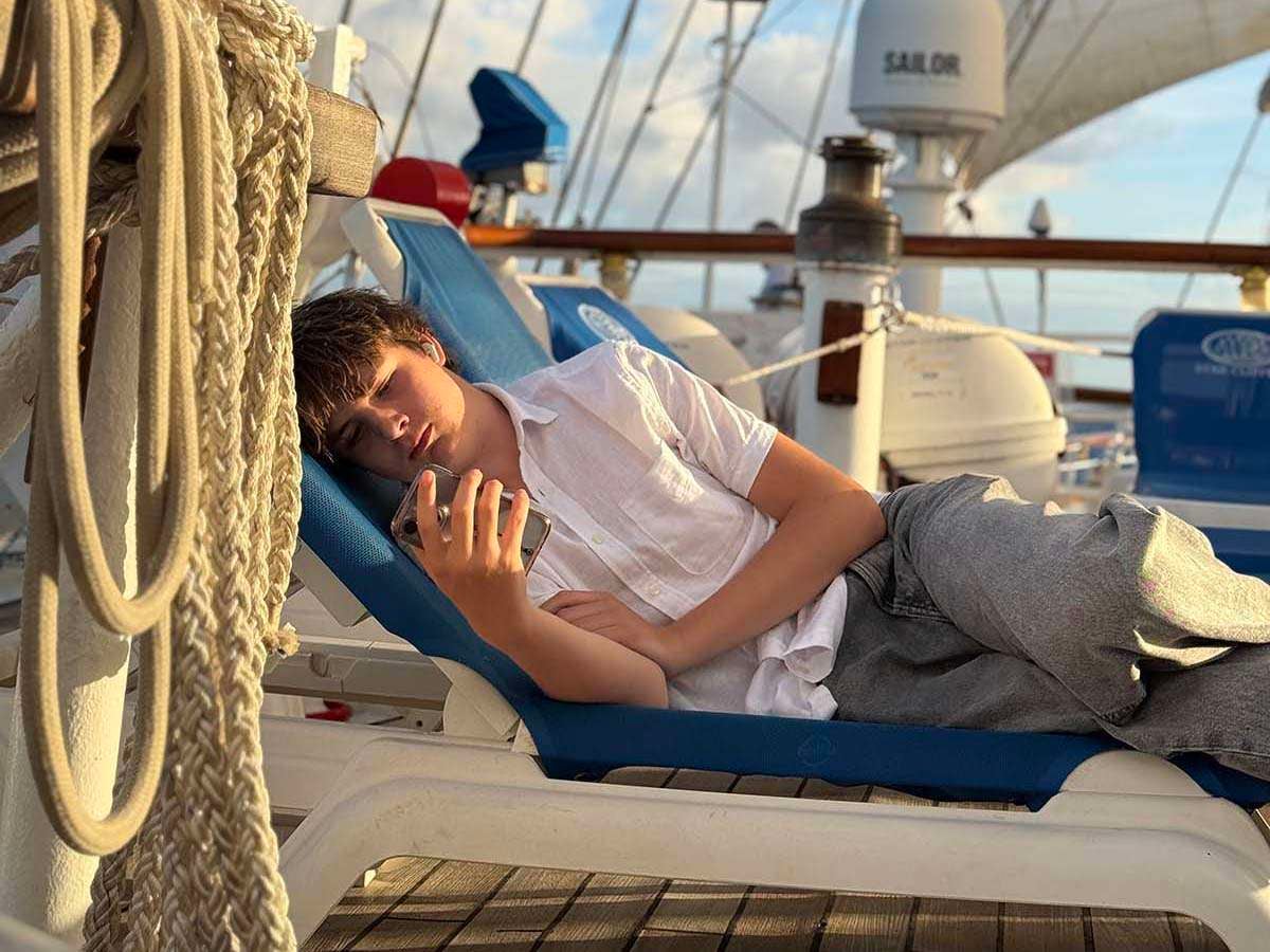 Star Clipper sun deck at golden hour with teen